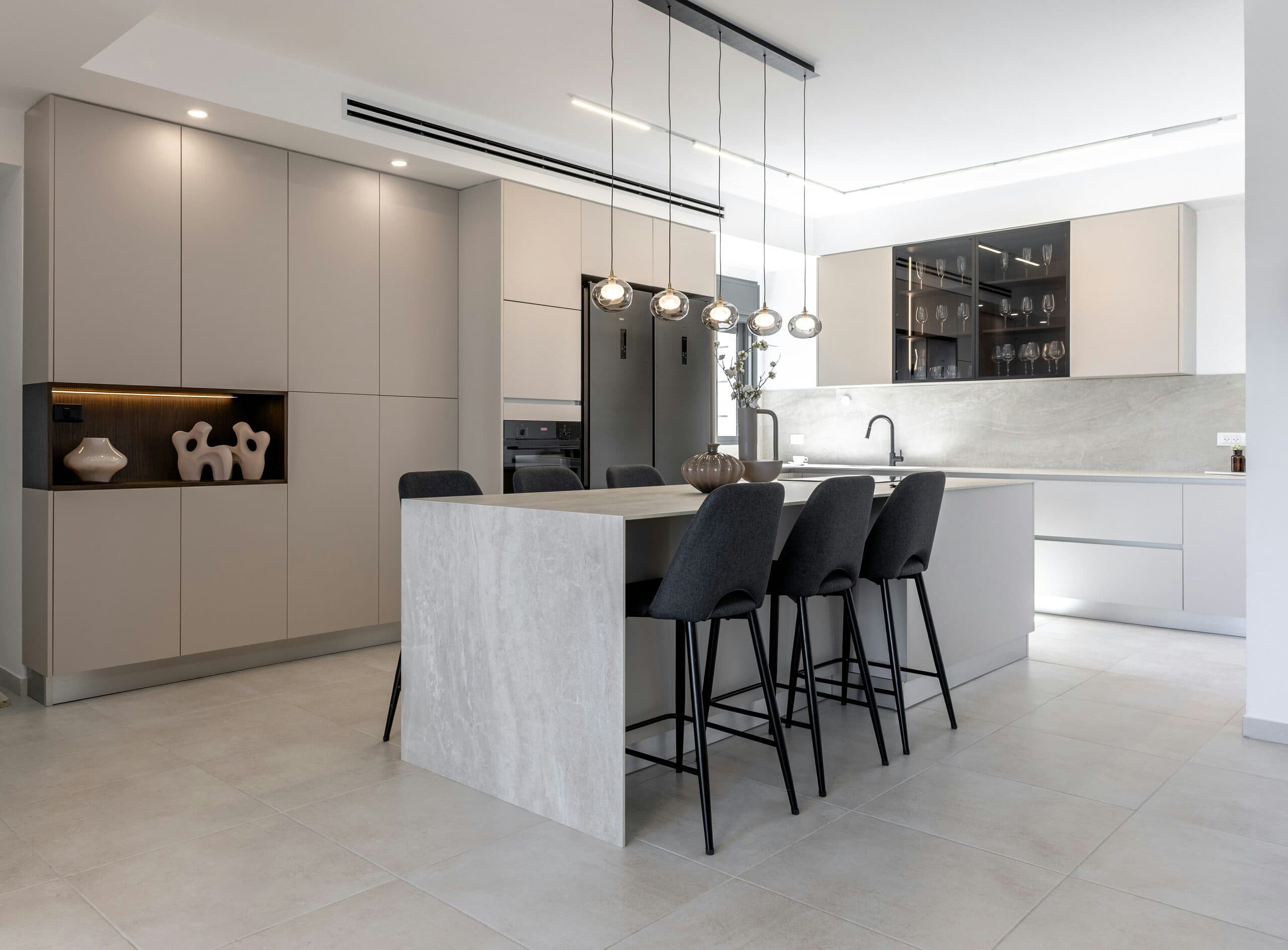 Warm, light-filled custom kitchen with natural stone island and white oak cabinetry